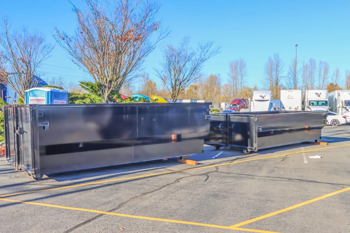 Professional dumpster rental service with roll-off container on residential driveway in Ludington